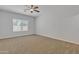 Spacious bedroom with a neutral color palette, a ceiling fan and natural light at 9261 W Sheridan St, Phoenix, AZ 85037