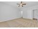 Bright and airy bedroom with neutral walls, plush carpeting, and ample closet space at 9261 W Sheridan St, Phoenix, AZ 85037