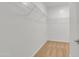Walk-in closet features a wall-mounted shelving system and neutral carpeting at 9261 W Sheridan St, Phoenix, AZ 85037