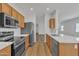 Modern kitchen boasts stainless steel appliances, quartz countertops, and stylish cabinetry at 9261 W Sheridan St, Phoenix, AZ 85037