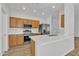Bright kitchen boasts stainless steel appliances, quartz countertops, and stylish cabinetry at 9261 W Sheridan St, Phoenix, AZ 85037