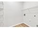 Bright laundry room with wood-look flooring and white wire shelving at 9261 W Sheridan St, Phoenix, AZ 85037