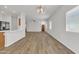 Expansive living area with views into the kitchen featuring modern lighting at 9261 W Sheridan St, Phoenix, AZ 85037
