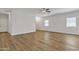 Spacious living room with updated floors, ceiling fan, and many windows at 9261 W Sheridan St, Phoenix, AZ 85037