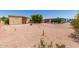 Large backyard with desert landscaping and a covered patio at 9347 E Edgewood Ave, Mesa, AZ 85208