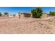 Backyard featuring a gravel covered ground, bushes and sheds at 9347 E Edgewood Ave, Mesa, AZ 85208