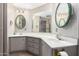 Bathroom featuring double sinks, framed mirrors, and neutral finishes at 9347 E Edgewood Ave, Mesa, AZ 85208