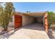 Spacious carport with wooden gate, providing shade and privacy at 9347 E Edgewood Ave, Mesa, AZ 85208