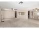 Bright living room with carpet flooring, ceiling fan and built in shelving at 9347 E Edgewood Ave, Mesa, AZ 85208