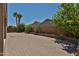 Large paver backyard featuring palm trees and privacy wall, perfect for entertaining at 9437 W Georgia Ave, Glendale, AZ 85305