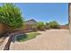 Beautiful paver backyard featuring privacy wall, lush trees and artificial turf at 9437 W Georgia Ave, Glendale, AZ 85305