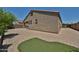 Rear view of property with pavers, stucco wall and artificial grass at 9437 W Georgia Ave, Glendale, AZ 85305