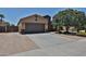 Charming single-story home featuring a two-car garage and desert landscaping at 9437 W Georgia Ave, Glendale, AZ 85305