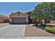 Charming single-story home featuring a two-car garage and desert landscaping at 9437 W Georgia Ave, Glendale, AZ 85305