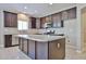 Kitchen featuring dark cabinets, stainless steel appliances, and a large island at 9437 W Georgia Ave, Glendale, AZ 85305