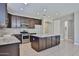 Well-lit kitchen featuring dark cabinets, stainless steel appliances, and a center island at 9437 W Georgia Ave, Glendale, AZ 85305