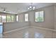 Bright living area featuring tile flooring, neutral walls, and sliding glass doors at 9437 W Georgia Ave, Glendale, AZ 85305