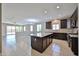 Open-concept living area with tile flooring, natural light, and kitchen access at 9437 W Georgia Ave, Glendale, AZ 85305