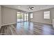 Spacious living room boasts wood flooring, ceiling fan and sliding glass doors to the backyard at 9437 W Georgia Ave, Glendale, AZ 85305