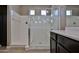 Elegant glass enclosed shower with a bench and a rainfall showerhead at 9437 W Georgia Ave, Glendale, AZ 85305