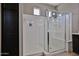 Elegant glass enclosed shower with a bench and a rainfall showerhead at 9437 W Georgia Ave, Glendale, AZ 85305