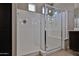 Elegant glass enclosed shower with a bench and a rainfall showerhead at 9437 W Georgia Ave, Glendale, AZ 85305