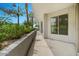 A neutral-toned covered balcony showing landscaping and building at 945 E Playa Del Norte Dr # 1016, Tempe, AZ 85288