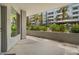 A relaxing covered balcony with green landscaping and partial building views at 945 E Playa Del Norte Dr # 1016, Tempe, AZ 85288