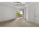 Bright bedroom featuring plush carpeting and access to a private balcony at 945 E Playa Del Norte Dr # 1016, Tempe, AZ 85288