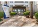 Inviting condo building entrance with desert landscaping, a covered entryway, and prominent signage at 945 E Playa Del Norte Dr # 1016, Tempe, AZ 85288