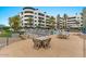 A shaded common area with a table and chairs next to a pool and lounge seating at 945 E Playa Del Norte Dr # 1016, Tempe, AZ 85288