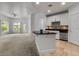 Open-concept kitchen with a breakfast bar overlooking the spacious living area and exterior views at 945 E Playa Del Norte Dr # 1016, Tempe, AZ 85288