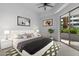 Bright main bedroom with a ceiling fan, sliding glass doors, and contemporary decor at 945 E Playa Del Norte Dr # 1016, Tempe, AZ 85288