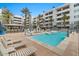 A sparkling blue pool with lounge chairs, a spa, and inviting community amenities at 945 E Playa Del Norte Dr # 1016, Tempe, AZ 85288