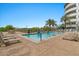 Bright swimming pool and jacuzzi with lounge chairs and manicured landscaping at 945 E Playa Del Norte Dr # 1016, Tempe, AZ 85288