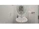Small bathroom with sink, stylish oval mirror, and modern faucet with white walls at 9920 E Tamery Ave, Mesa, AZ 85212