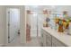 Bright bathroom with a glass-enclosed shower, vanity with white cabinets, and decorative shower curtain at 9920 E Tamery Ave, Mesa, AZ 85212