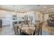 Bright dining area featuring a wooden table, seating for six, and an adjacent modern kitchen at 9920 E Tamery Ave, Mesa, AZ 85212