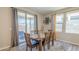 Dining area featuring a wooden table, chairs, and sliding glass doors at 9920 E Tamery Ave, Mesa, AZ 85212