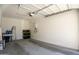 Spacious garage featuring concrete flooring and a water heater system on the back wall at 9920 E Tamery Ave, Mesa, AZ 85212