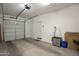 Clean garage featuring a metal door, concrete flooring, and plenty of open space at 9920 E Tamery Ave, Mesa, AZ 85212