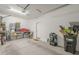 Organized two-car garage featuring storage shelves, tools, and ample space for vehicles at 9920 E Tamery Ave, Mesa, AZ 85212