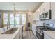 Modern kitchen featuring stainless steel appliances, gas range, and quartz countertops with ample cabinetry at 9920 E Tamery Ave, Mesa, AZ 85212
