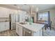 Well-equipped kitchen with stainless steel appliances, quartz countertops, and convenient island layout at 9920 E Tamery Ave, Mesa, AZ 85212