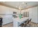 Contemporary kitchen featuring white cabinetry, stainless steel appliances, and spacious island seating at 9920 E Tamery Ave, Mesa, AZ 85212