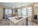 Stylish kitchen island with quartz countertops, stainless steel appliances, and natural light from windows at 9920 E Tamery Ave, Mesa, AZ 85212
