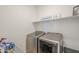 Bright laundry room with modern front-load washer and dryer set and simple Laundry Co decor at 9920 E Tamery Ave, Mesa, AZ 85212