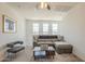Cozy upstairs living area with a comfortable sectional sofa, ceiling fan, and three bright windows at 9920 E Tamery Ave, Mesa, AZ 85212