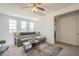 Bright living room features a modern ceiling fan, a comfortable sectional, and plentiful natural light at 9920 E Tamery Ave, Mesa, AZ 85212