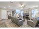 Spacious living room featuring hardwood floors, ample seating, and abundant natural light at 9920 E Tamery Ave, Mesa, AZ 85212